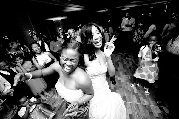 black and white photo - bride and family and friends dancing at the reception -photo by Houston based wedding photographer Adam Nyholt